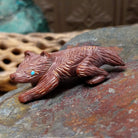 Badger Zuni fetish carving by Karen Zunie in reddish stone with etched fur and turquoise inlaid eyes.