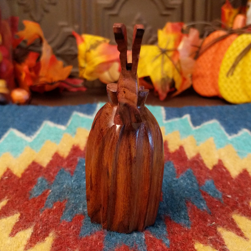 back view- Wooden barrel cactus with a hummingbird on top.