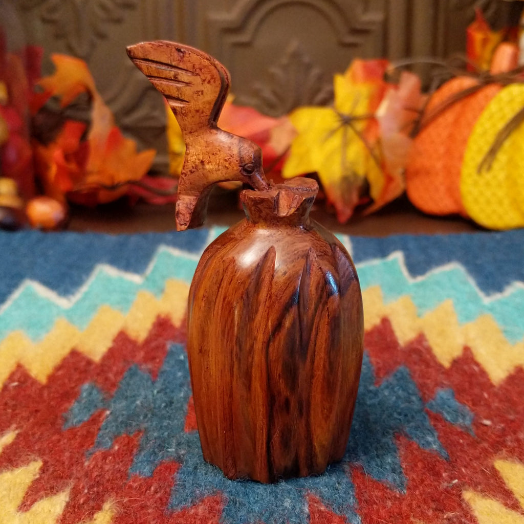 Ironwood carved into a smooth carving of a barrel cactus and hummingbird.