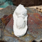 Zuni bear cub fetish carving by Adrian Cachini featuring two white stone bears with turquoise inlaid eyes resting on a carved base.