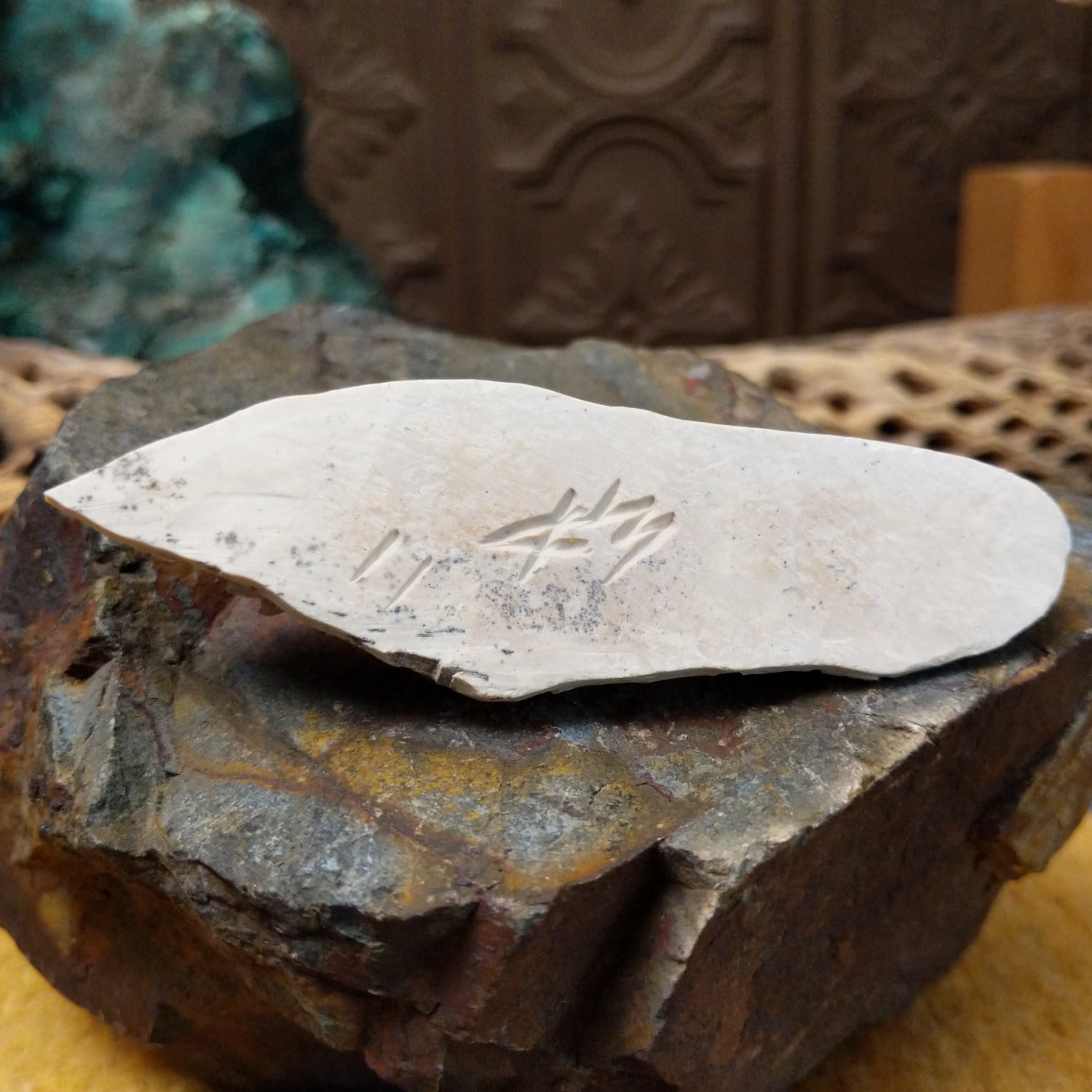 Close up of artist's etched signature. 
