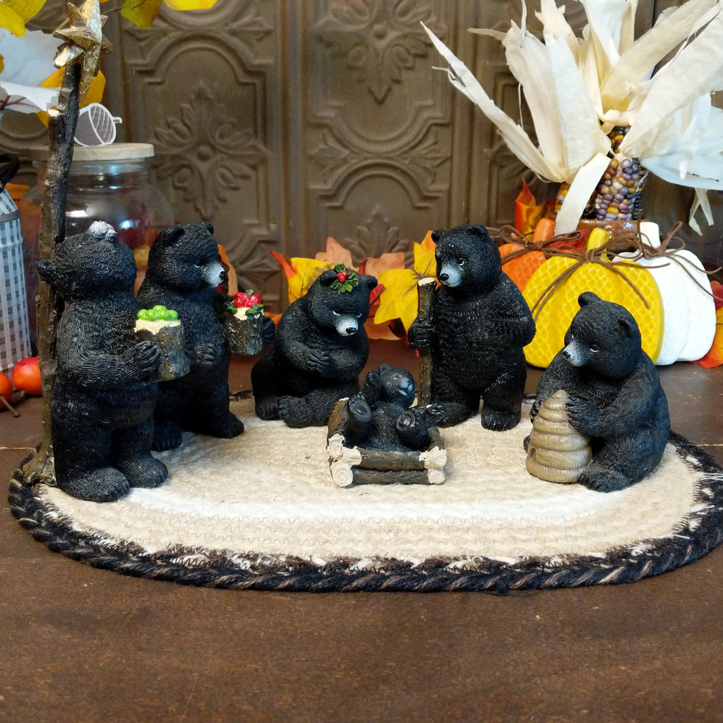 Resin black bears depicting a nativity scene with detailed paints.