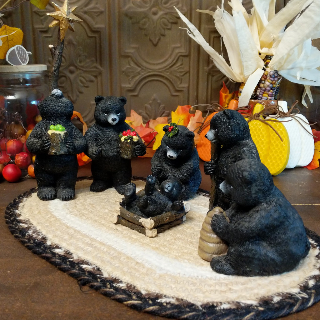 Resin black bears depicting a nativity scene with detailed paints.