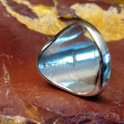 The artisan's stamped signature is found on the interior of the ring.