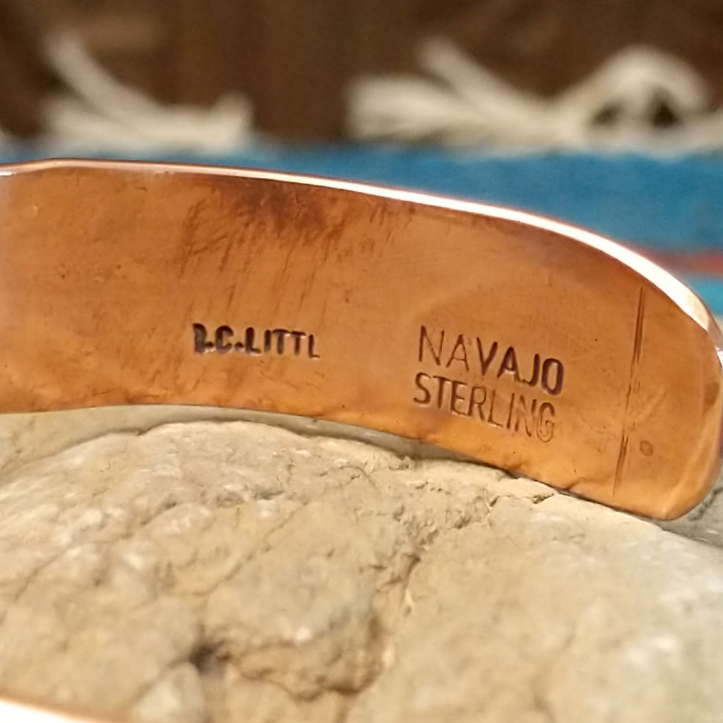 Close-up of the artisan's stamped signature.