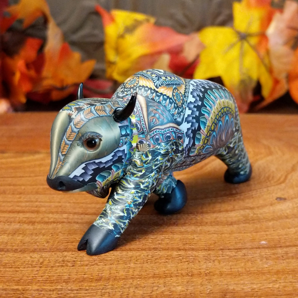 Decorative buffalo figurine with intricate patterns on a wooden surface