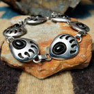 Sterling silver bear paw shadowbox bracelet by George Jones with a black onyx stone and hand-stamped Southwestern details.