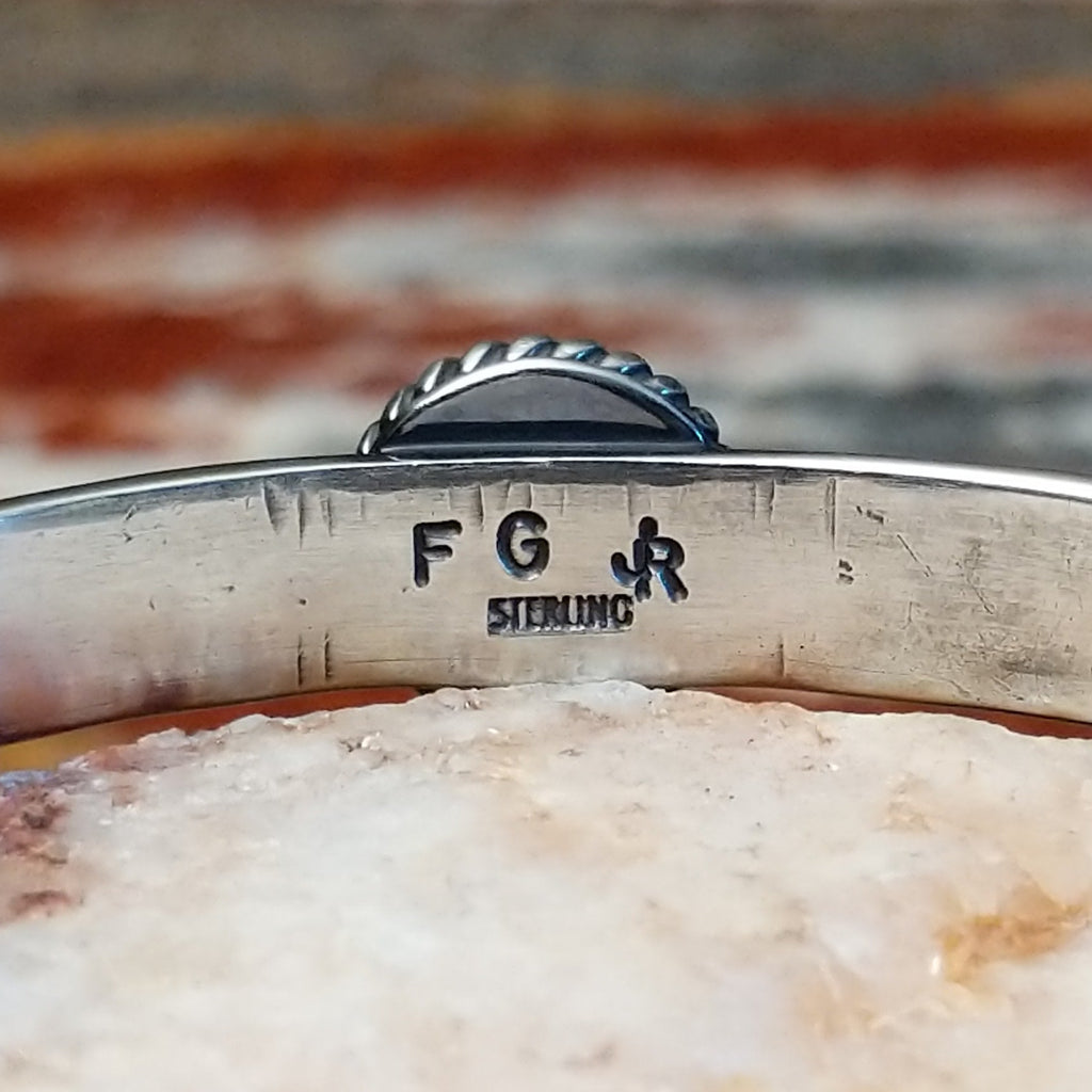 Close-up of the artisan's stamped signature.