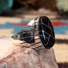 Sterling silver ring with geometric cannel work and black onyx inlay.