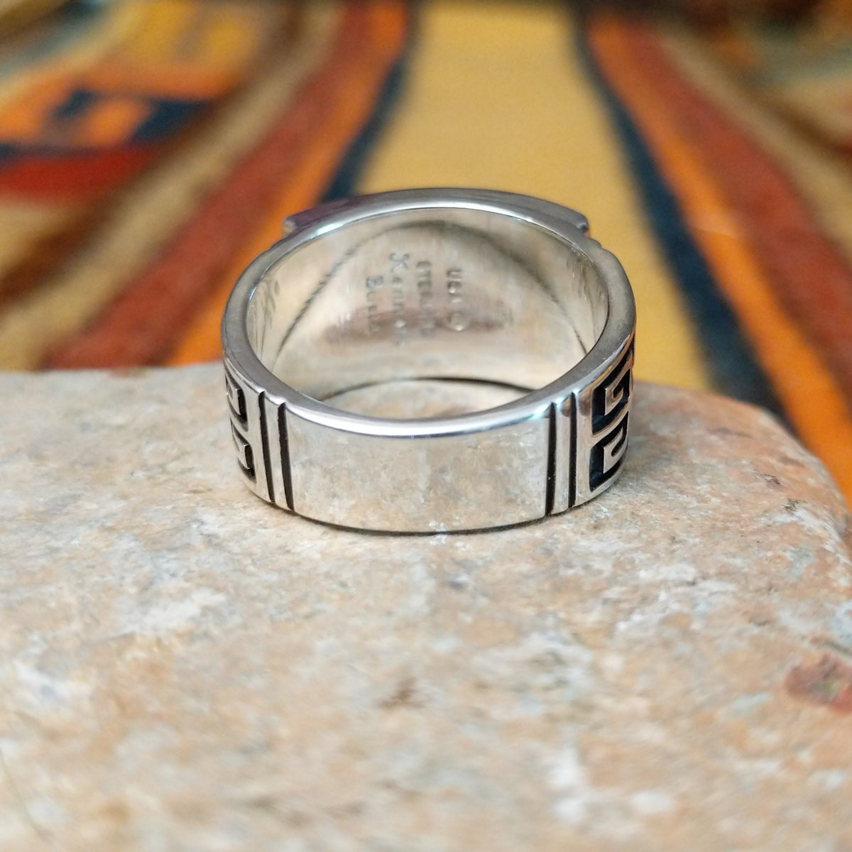 Black Onyx & Manmade Opal Ring by Kenneth Bitsie featuring geometric black onyx and iridescent manmade opal inlay set in a wide sterling silver band with a Southwestern design; underside view.