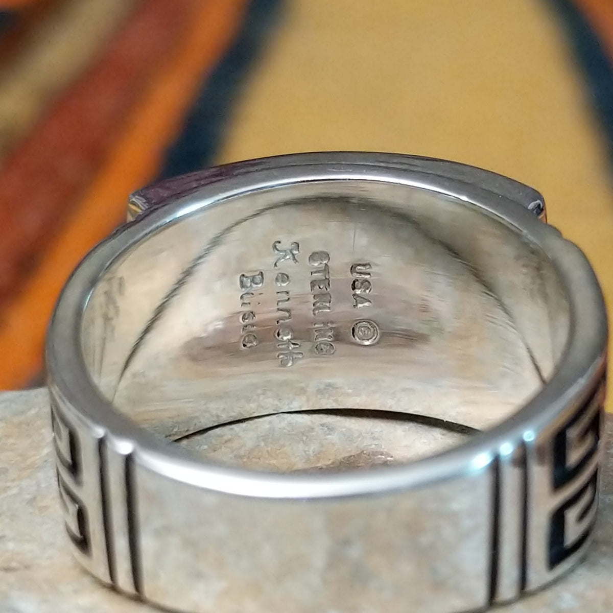 Black Onyx & Manmade Opal Ring by Kenneth Bitsie featuring geometric black onyx and iridescent manmade opal inlay set in a wide sterling silver band with a Southwestern design; artisan and Sterling Silver stamp.