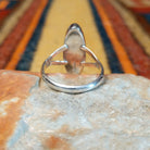 Black Onyx Ring by Cathy Webster featuring an elongated oval polished black onyx stone set in sterling silver with a smooth bezel and open split-shank band; underside view.