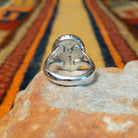 Rear view of a silver black onyx ring showing the open split-shank construction and interior Artist stamps.