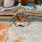 Sterling silver ring by Larson Lee featuring a large elongated oval black onyx cabochon framed by twisted silver rope and geometric silver detailing; underside view.