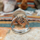 Sterling silver ring by Larson Lee featuring a large elongated oval black onyx cabochon framed by twisted silver rope and geometric silver detailing; artisan and Sterling Silver stamp.