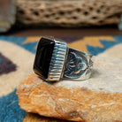 Handcrafted Navajo sterling silver ring by Murphy Platero featuring a polished black onyx cabochon set in a traditional Southwestern silver setting with a timeless, understated design; side view.