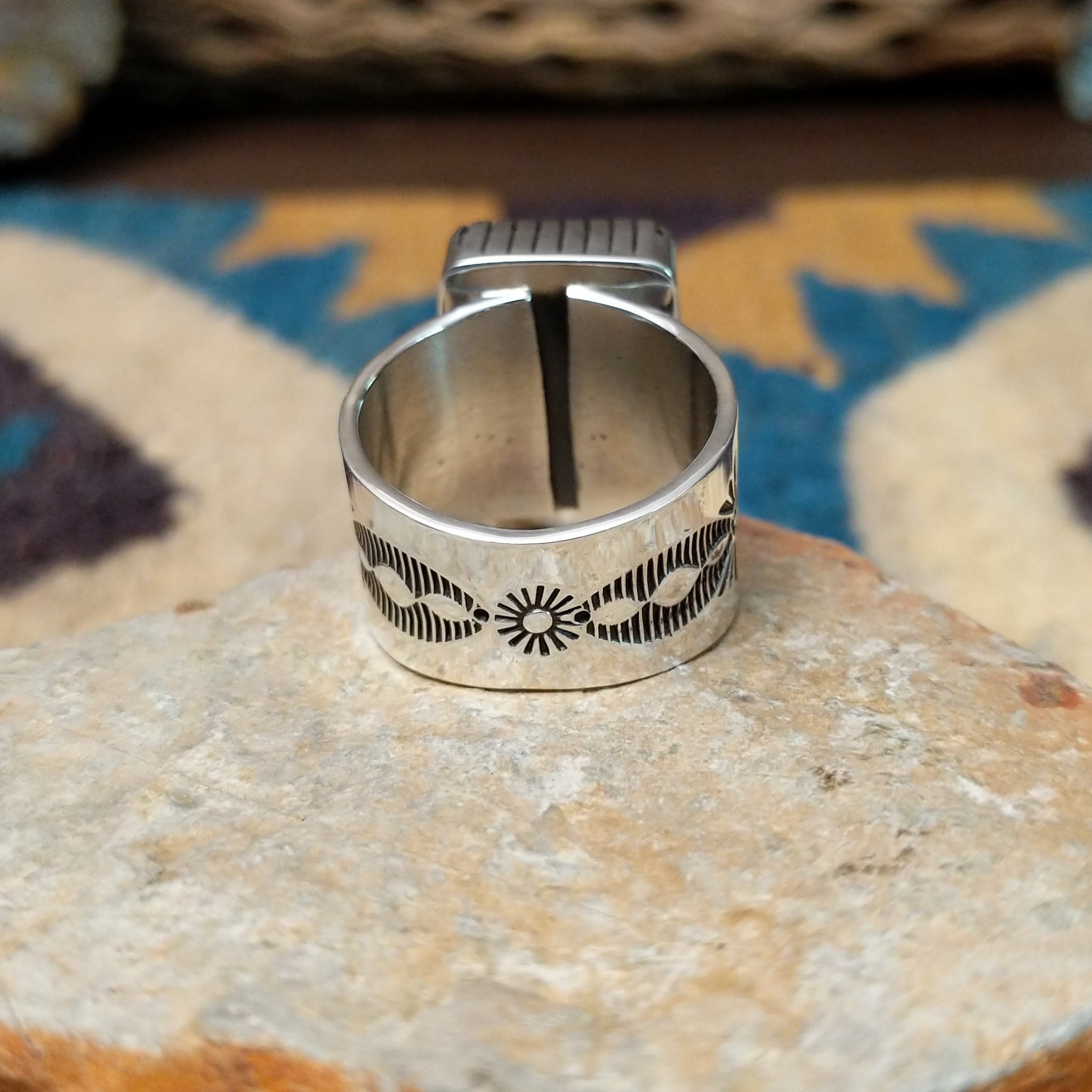 Handcrafted Navajo sterling silver ring by Murphy Platero featuring a polished black onyx cabochon set in a traditional Southwestern silver setting with a timeless, understated design; underside view.