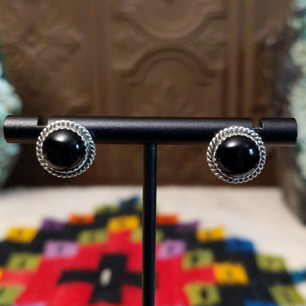 Black Onyx Round Earrings by Peggy Skeets featuring polished round black onyx cabochons set in silver with detailed twisted rope borders.
