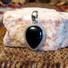 Teardrop shaped pendant with black onyx set in the bezel and framed by twisted rope accents.
