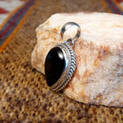 Teardrop shaped pendant with black onyx set in the bezel and framed by twisted rope accents.