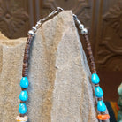 Beaded Blue Gem turquoise and shell necklace strung along the sterling silver chain in a patterned design.