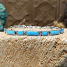 Sterling silver link bracelet with blue, manmade opal set in rectangular bezels.