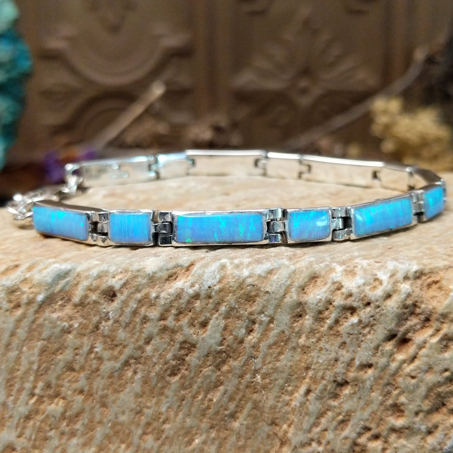 Sterling silver link bracelet with blue, manmade opal set in rectangular bezels.
