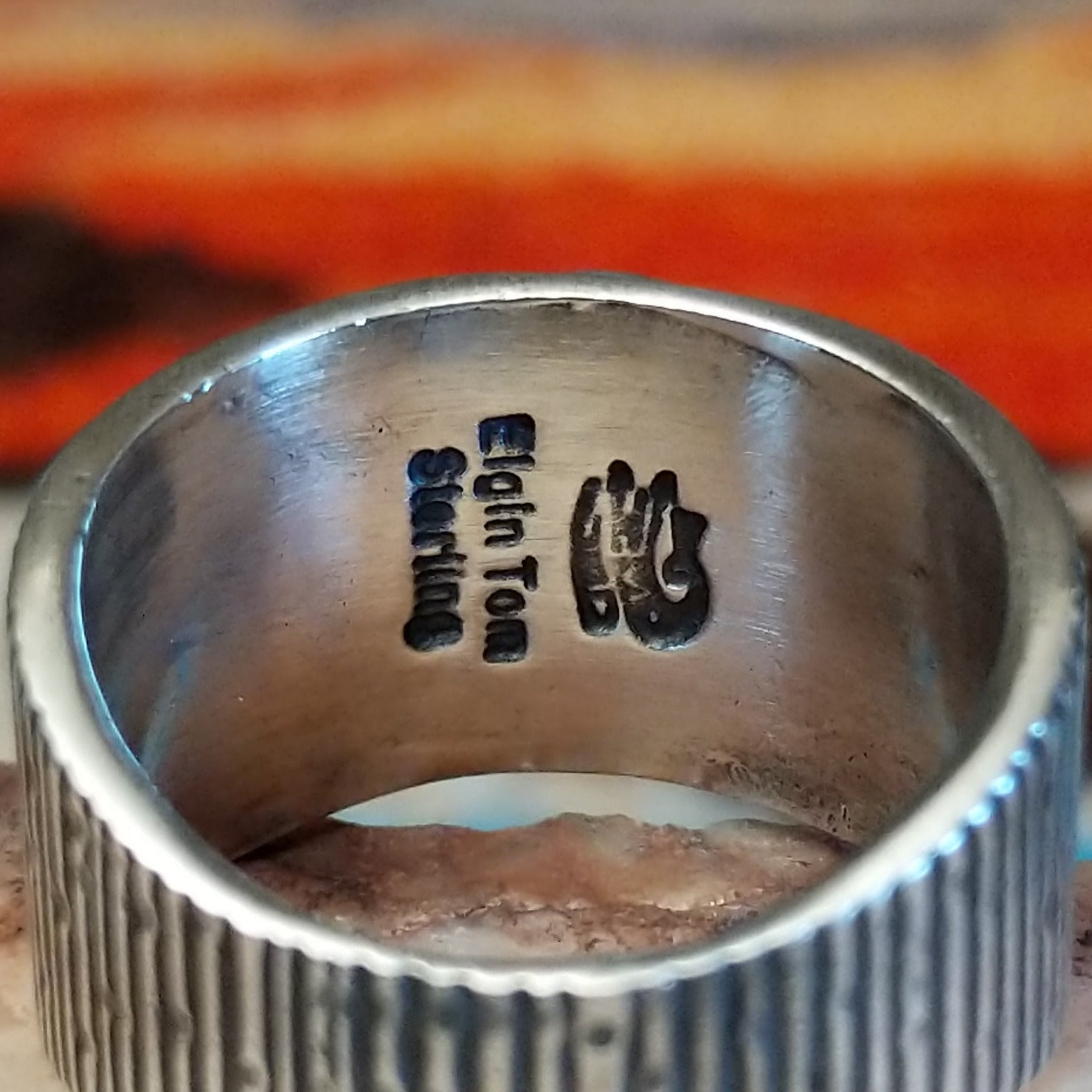Close-up of the artisan's stamped signature.