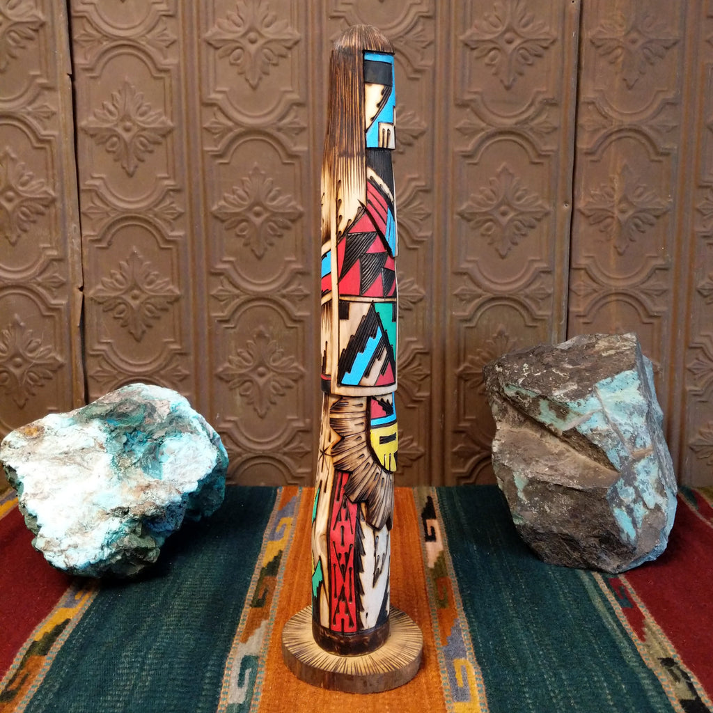 Shalako kachina with a blue face and various motifs in colorful paints.