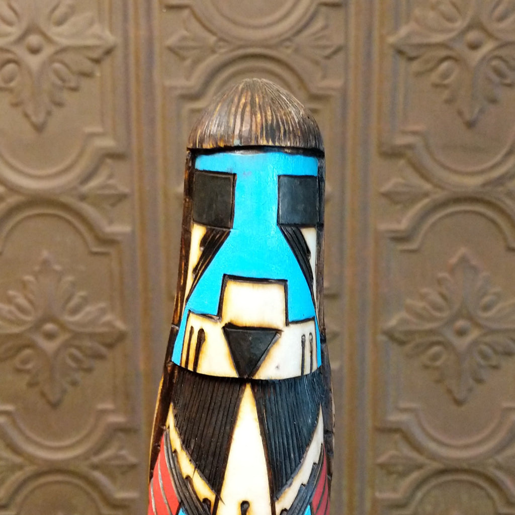 Close-up of the blue face of the carving.