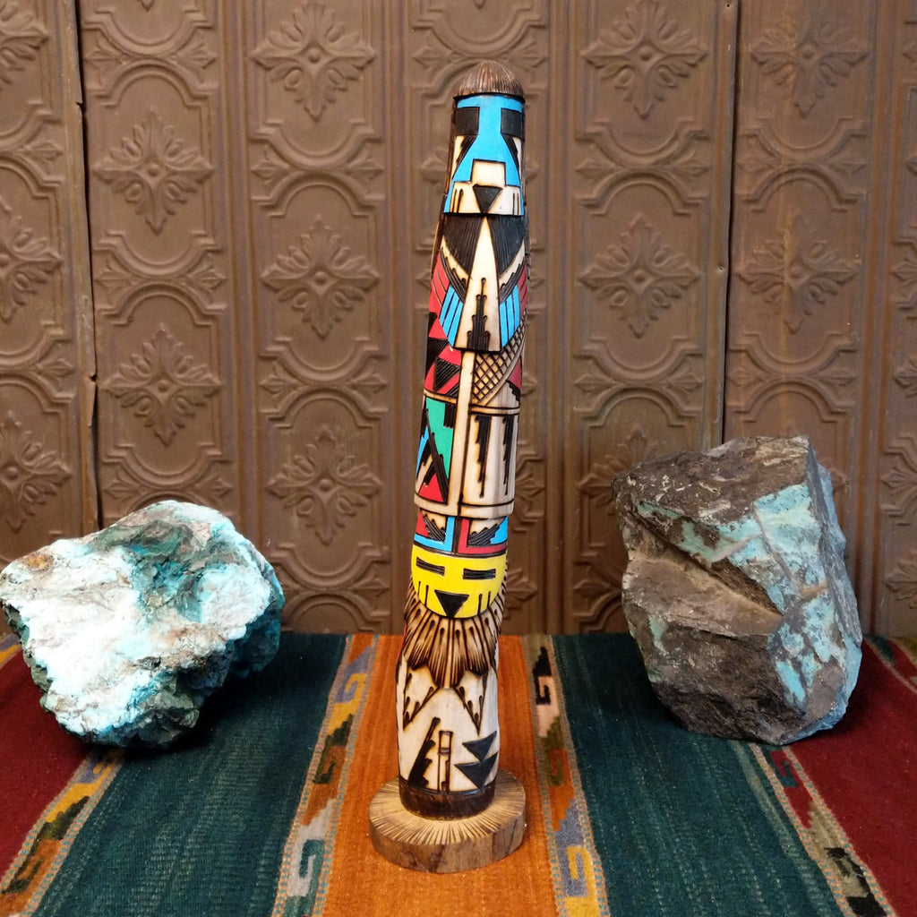 Shalako kachina with a blue face and various motifs in colorful paints.