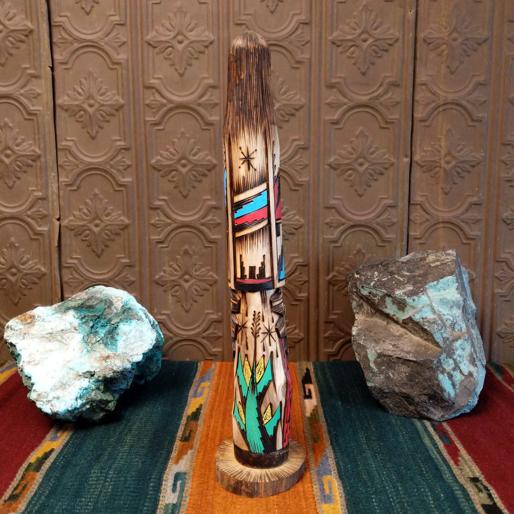 Shalako kachina with a blue face and various motifs in colorful paints.