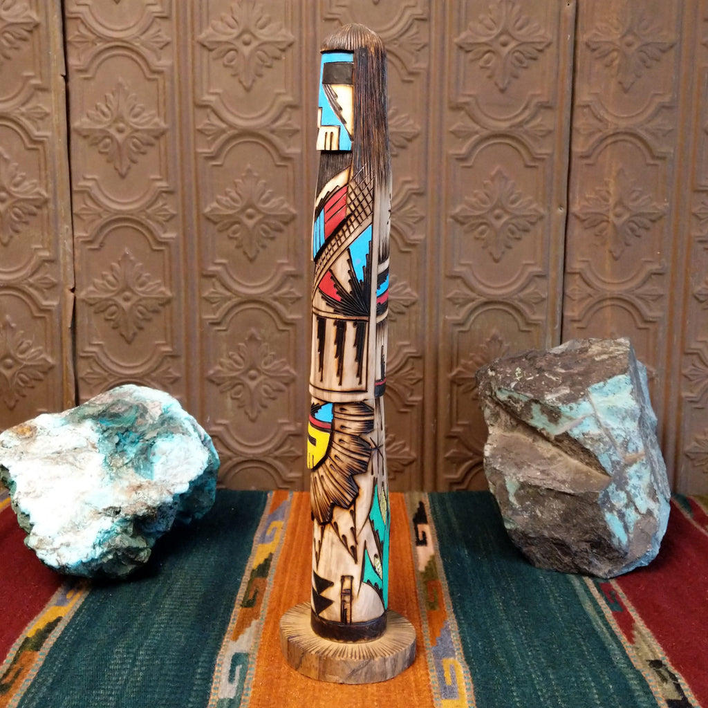 Shalako kachina with a blue face and various motifs in colorful paints.