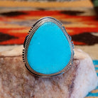Sterling silver ring with Kingman turquoise set in the large bezel, framed by the stamped setting.