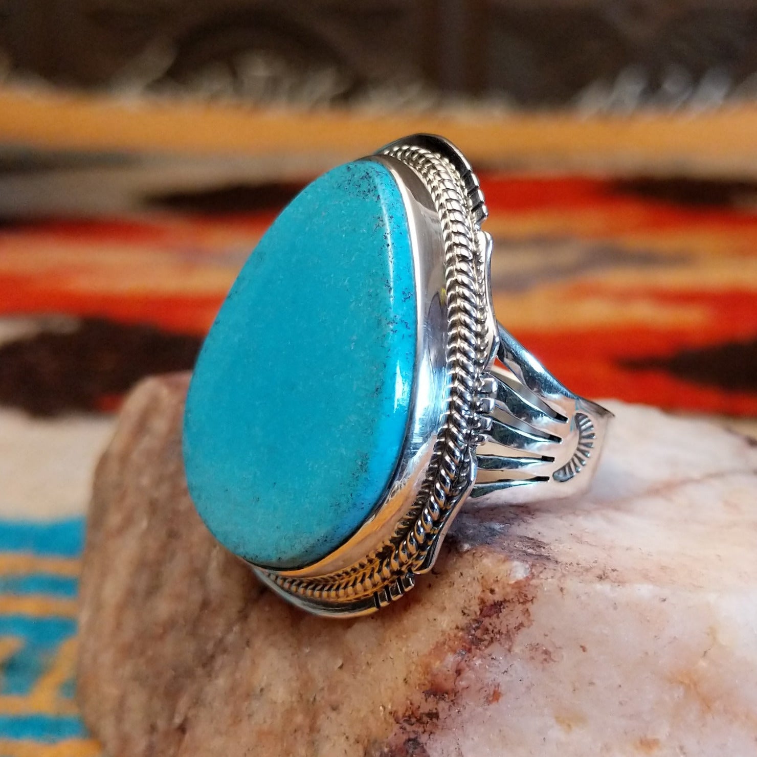 Sterling silver ring with Kingman turquoise set in the large bezel, framed by the stamped setting.