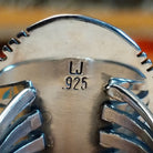 Close-up of the artisan's stamped signature.