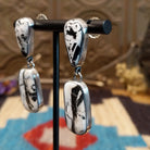 Sterling silver earrings with white buffalo stones set in bezels.