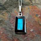Handcrafted sterling silver turquoise and black onyx inlay pendant by Harlan & Monica Coonsis, featuring a rectangular geometric design.