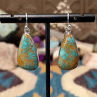 Handcrafted sterling silver teardrop earrings by Lowell Draper featuring natural Boulder Turquoise with vibrant blue coloring and golden-brown matrix on French hooks.