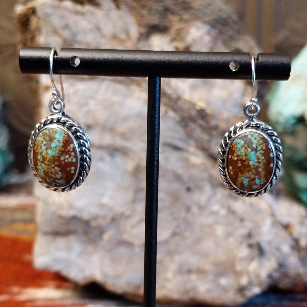 Boulder turquoise set in sterling silver twisted rope bezels of the earrings.