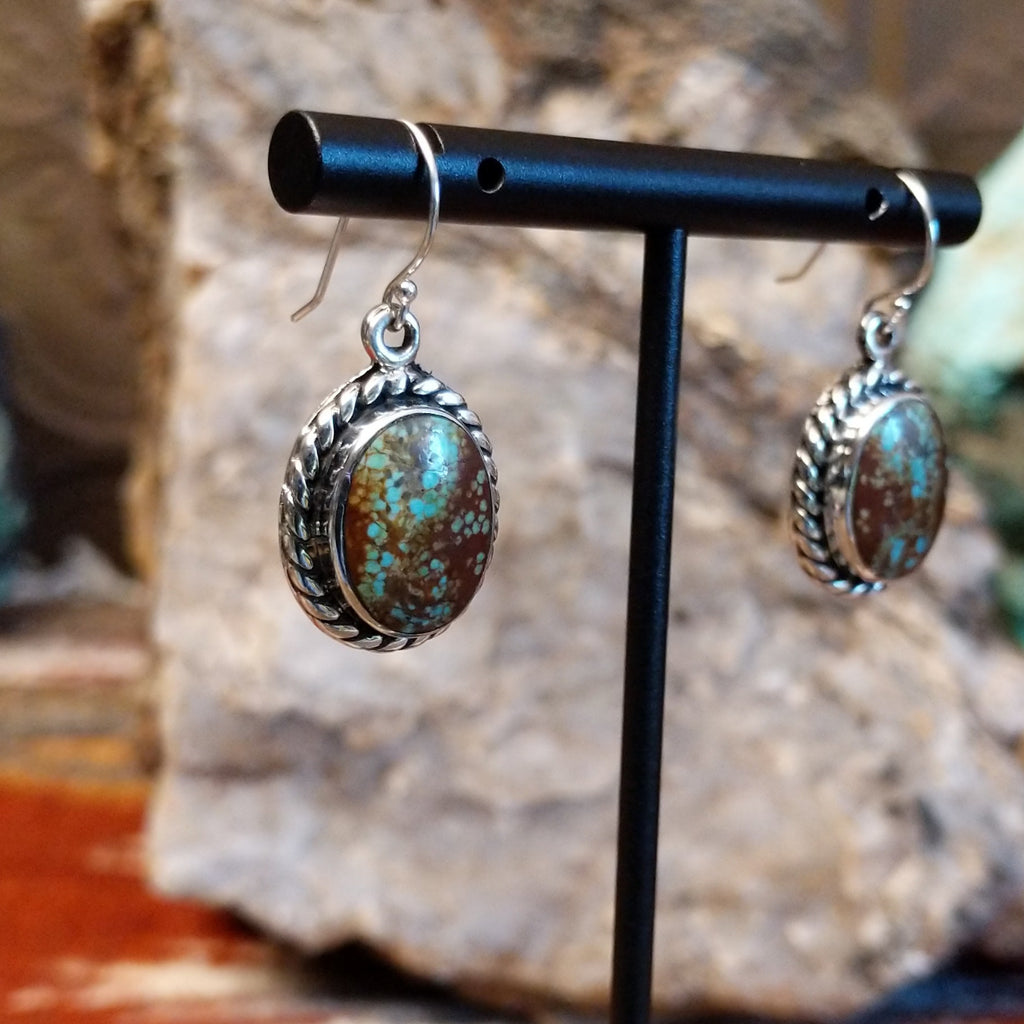 Boulder turquoise set in sterling silver twisted rope bezels of the earrings.