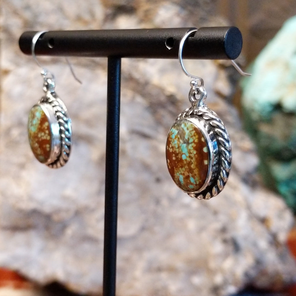 Boulder turquoise set in sterling silver twisted rope bezels of the earrings.