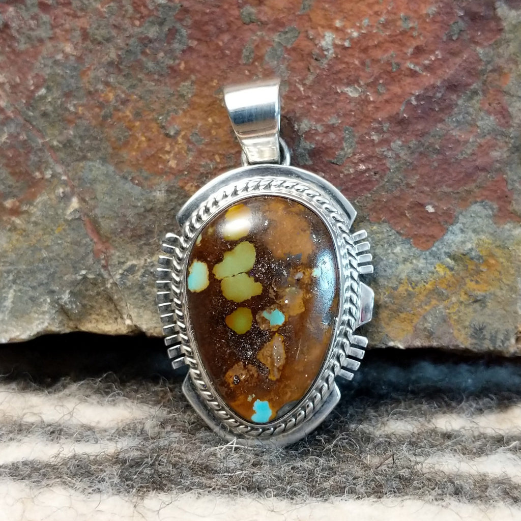 Boulder turquoise set in sterling silver creating a pendant.