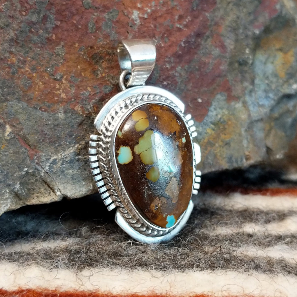 Boulder turquoise set in sterling silver creating a pendant.