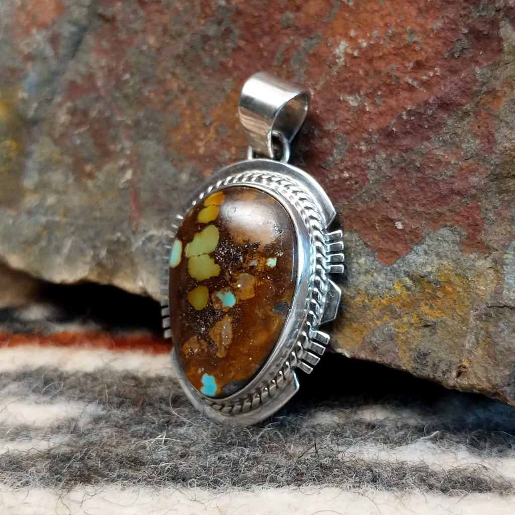 Boulder turquoise set in sterling silver creating a pendant.