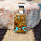 Sterling silver pendant with boulder turquoise set in the rectangular bezel.