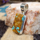 Sterling silver pendant with boulder turquoise set in the rectangular bezel.
