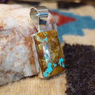 Sterling silver pendant with boulder turquoise set in the rectangular bezel.