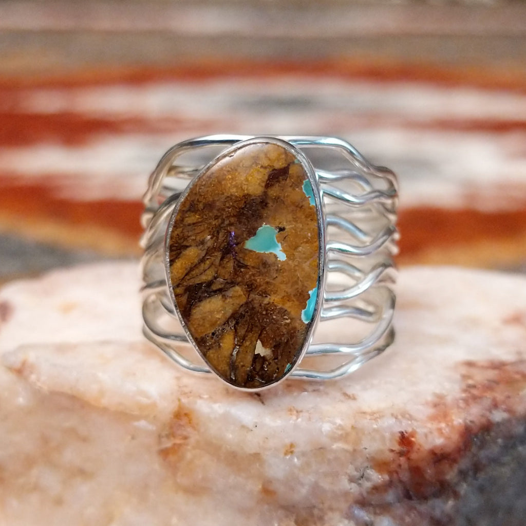 Sterling silver ring with boulder turquoise set in the smooth bezel and layered wire band.
