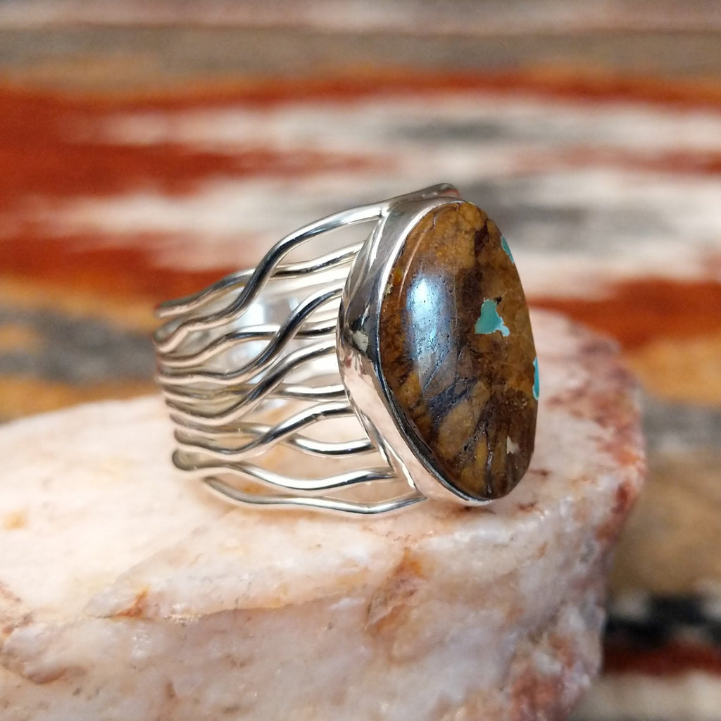 Sterling silver ring with boulder turquoise set in the smooth bezel and layered wire band.